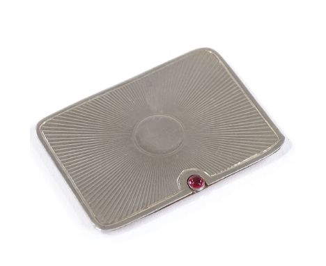 A rectangular silver double postage stamp case, with sliding action, cabochon garnet thumb piece, and engine turned sunburst 