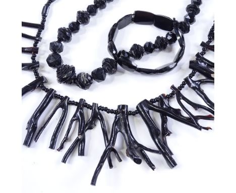 A long black coral stick necklace, length 60cm, together with a faceted jet necklace and bracelet (3) 