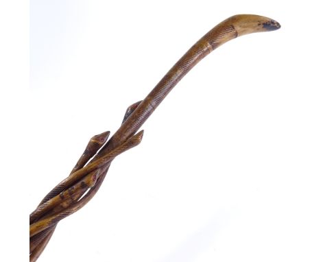 An African carved wood walking stick with entwined snakes 