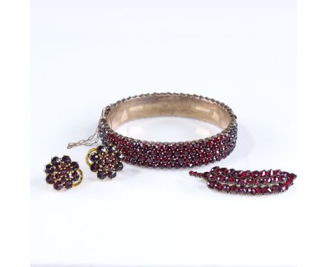 A group of Victorian garnet jewellery, comprising hinged bangle, wheatsheaf brooch, and pair of earrings, 35.7g total (3) 