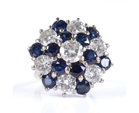 An 18ct white gold sapphire and diamond cluster cocktail ring, central diamond approx 0.5ct, setting height 21.5mm, size K, 9