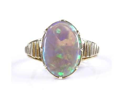 An unmarked gold black opal panel ring, with open-work bridge and ribbed shoulders, unmarked settings test as 14ct gold, sett