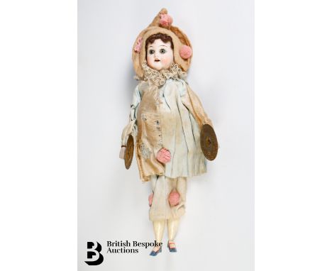 German doll with hand painted bisque head with open mouth revealing small teeth, wooden limbs with a squeeze mechanism that c