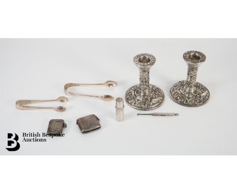 Pair of silver candlesticks (lightly weighted), Birmingham hallmark dated 1969, approx 9.5 cms h; two silver sugar nips, silv