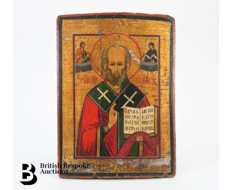 A 19th century Russian icon, half-length portrait of St Nicholas, depicted with an open gospel flanked by the Saviour and Mot