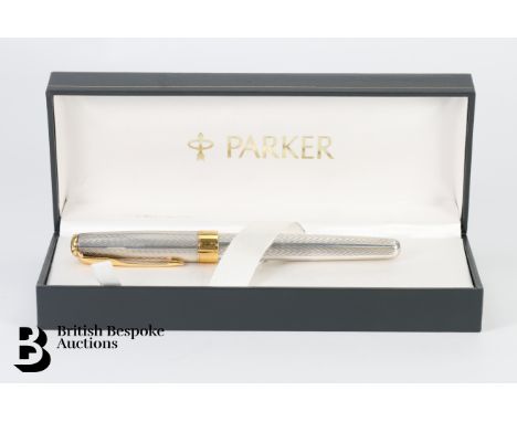 A silver and gold plated Sonnet Parker fountain pen, having an engine-turned barrel with Parker 18k nib, in the original pres
