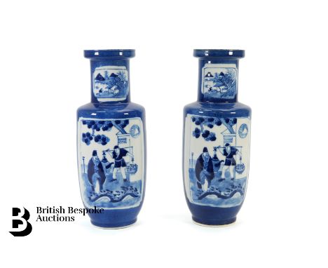 Pair of Chinese blue and white vases, with two opposing panels depicting figures in a garden setting, four character Kangxi m