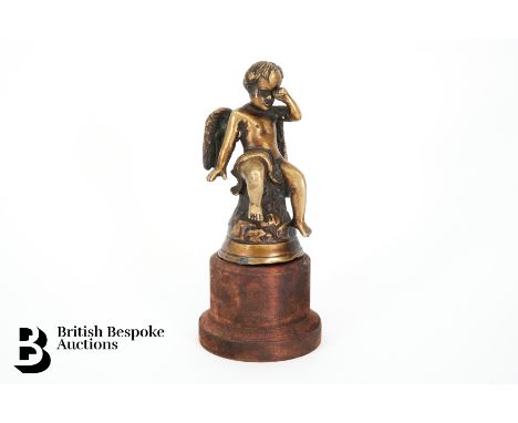 An early Edwardian period bronze crying cherub mascot, sitting on a tree trunk crying, circa 1908-1912. Measures approx. 16.5