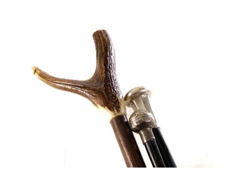 Two silver topped walking canes, one with engraved swag design, the other AF, together with a antler handled stick (3)