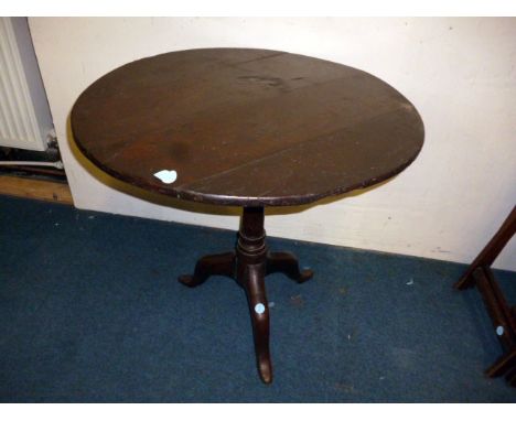 An 18th century circular top tripod table 