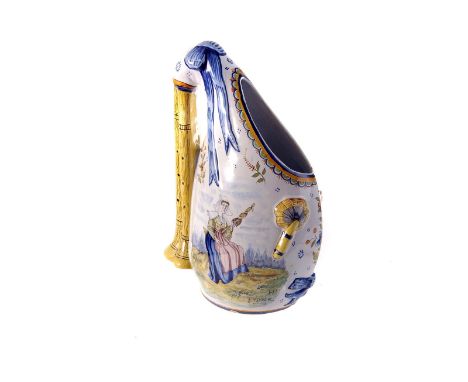 A late 19th century Quimper ceramic vase, in the form of a set of bagpipes, having floral decoration and image of a seated la