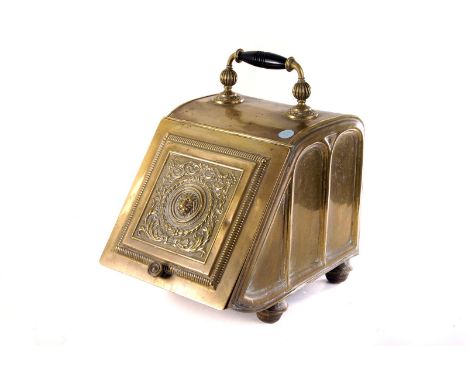 A vintage brass coal scuttle, having lion mask design to front, on four short legs 