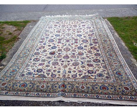 A large beige ground carpet, having decorative floral centre, flanked by a floral multi-border, approx. 360cm by 235cm