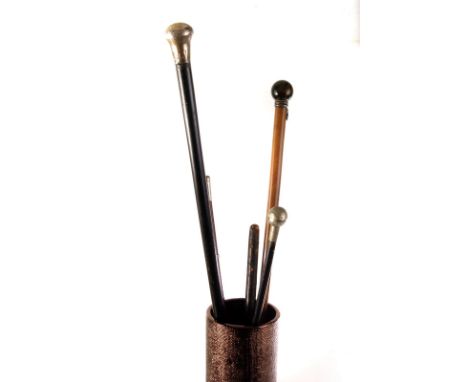 A group of five swagger sticks, including a tiger's eye and white metal topped example, a military example, two white metal t