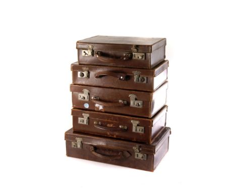 A group of five vintage brown leather attaché cases 
