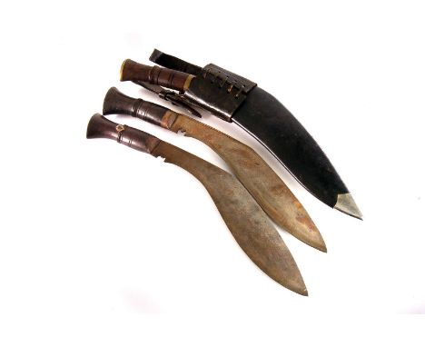 A Kukri knife, in leather scabbard with two smaller knives, together with two other Kukri knives (3)