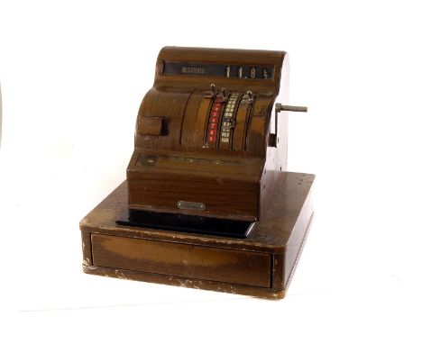A vintage National Cash Register, having hand wound mechanism to side