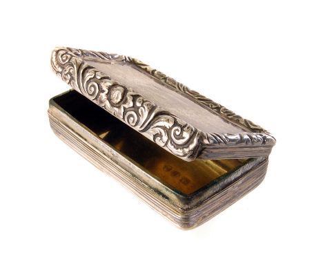 A George IV silver snuff box, with reeded base and floral lid, marked Birmingham 1824, by John Betteridge
