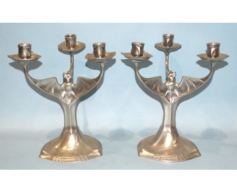 Kayserzinn, attributed to Hugo Leven, a pair of three-branch 'bat' candelabra, each removable sconce above a shaped candle ar