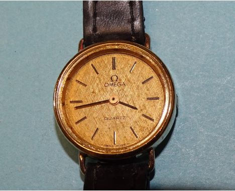 Omega, a ladies' Omega Quartz wrist watch, the gilt face with baton numerals, on leather strap.