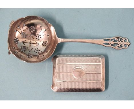 A silver tea strainer with decorative pierced terminal and bowl, Sheffield 1937 and an engine-turned matchbook holder, Birmin