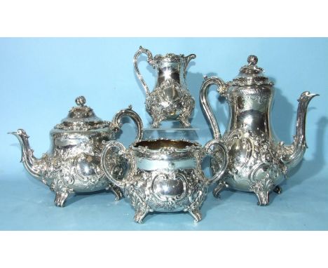 A Victorian four-piece tea and coffee service with floral and scroll repoussé and engraved decoration, each piece with scroll