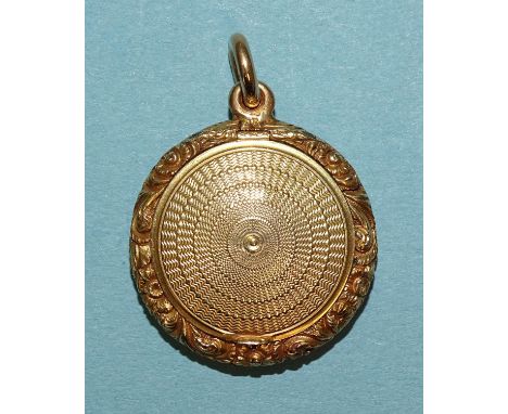 A 19th century gold mourning locket with foliate embossed and chased edge and engine-turned hinged sides marked '18' to loop,