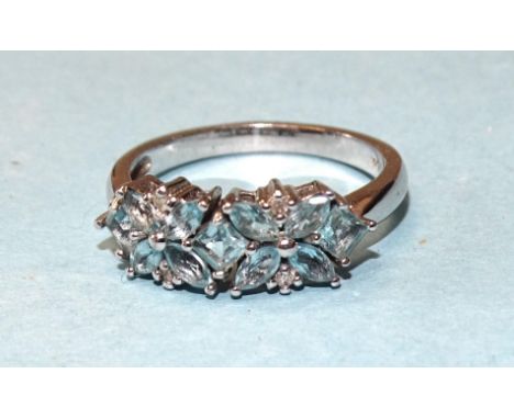A 9ct white gold ring set a cluster of blue topaz, with diamond accents, size R, 3.4g.