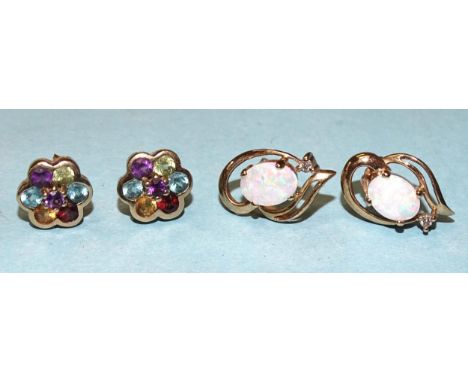 A pair of 9ct gold earrings, each set an oval opal and diamond point, 18mm long and a pair of 9ct gold multi-gem cluster ear 