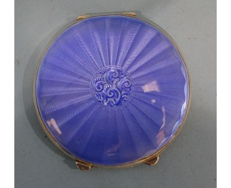 A George VI silver and enamel powder compact of lenticular form, the cover with blue enamel radial striped and floral centre 