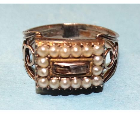 An unusual Georgian mourning ring, the rectangular hinged pearl-edged hair-locket revealing a tiny vinaigrette with hinged gi