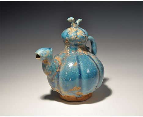 An undated archaistic turquoise-glazed ceramic gourd vessel with scrolled handle, bird above and bird-head spout. 476 grams, 