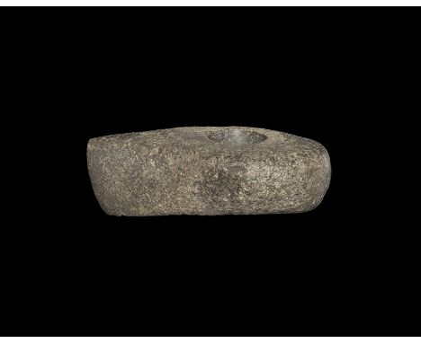 Neolithic, 4th-2nd millennium BC. A pecked and ground axe-hammer with central perforation for hafting. 516 grams, 13.5cm (5 1