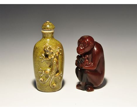 20th century AD. A mixed group of snuff bottles comprising: one a composition monkey with two small monkeys on the raised kne