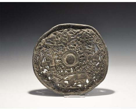 19th century AD. A cast lead alloy discoid plaque with central rosette, lozengiform openwork panel of palmettes, four figural