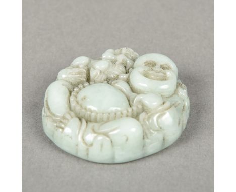 A Chinese carved celadon jade pendantWorked with the figure of Buddha and a temple lion.  4.5 cm diameter.    CONDITION REPOR