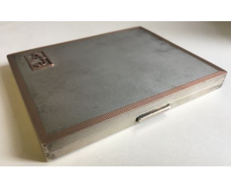 A silver and silver gilt cigarette case, hallmarked Birmingham 1944, maker's mark of WH Manton Ltd and retailed by Dunhill, L