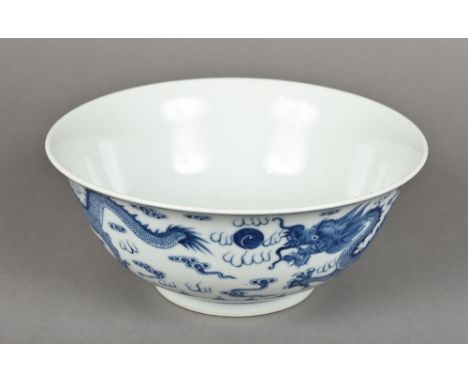 A late 19th century Chinese blue and white porcelain bowlFinely painted with dragons chasing flaming pearls, blue painted six