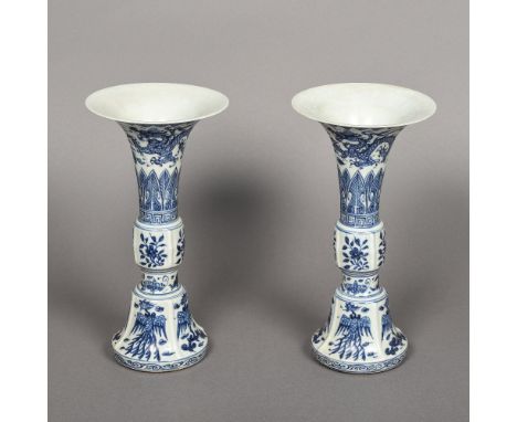 A pair of Chinese blue and white porcelain gu vasesEach of typical form decorated with mythical beasts and floral sprays, blu