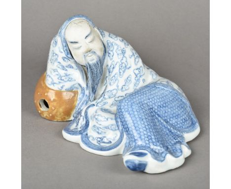 A Chinese blue and white porcelain figureModelled as a reclining sage.  24 cm long.    CONDITION REPORTS:  Generally in good 