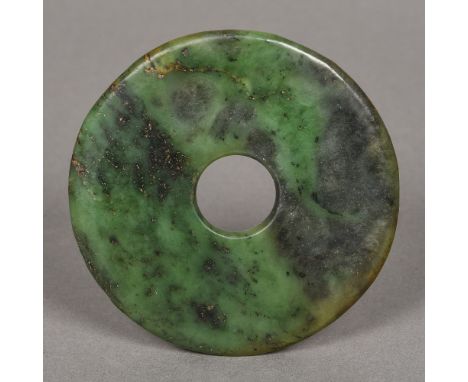 A Chinese carved green jade bi disc10 cm diameter.    CONDITION REPORTS:  Generally good condition, expected wear.