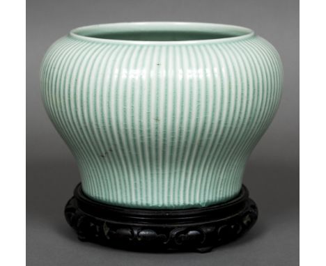 A Chinese porcelain baluster vase on standOf ribbed form with allover celadon glazed.  The vase 18 cm high.    CONDITION REPO