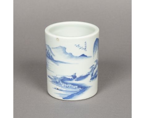 A Chinese blue and white porcelain brush potDecorated with a figure fishing in a continuous river landscape.  12.5 cm high.  