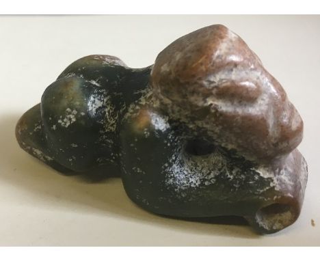 A South American carved green and russet jade pendantWorked as a crouching figure.  5.5 cm long.    CONDITION REPORTS:  Gener