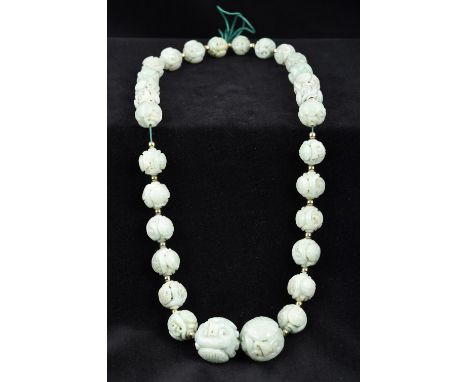 A Chinese carved jade bead necklaceApproximately 50 cm long.    CONDITION REPORTS:  Generally in good condition, some minor f