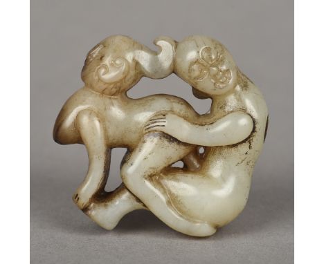 A Chinese mutton fat jade roundelOf pierced erotic form.  5 cm high.    CONDITION REPORTS:  Generally good condition, expecte