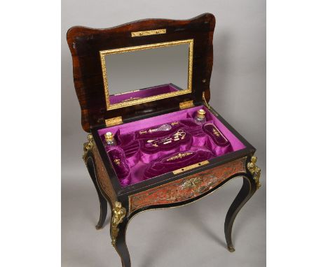 A 19th century boulle lady's work tableThe ormolu mounted hinged serpentine rectangular top enclosing the velvet lined fitted