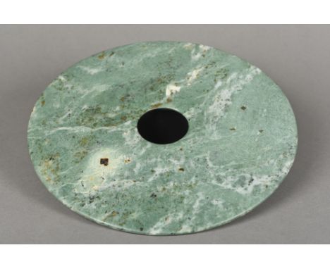 A jade bi discOf typical form.  28.25 cm diameter.    CONDITION REPORTS:  Generally good condition, expected wear. 