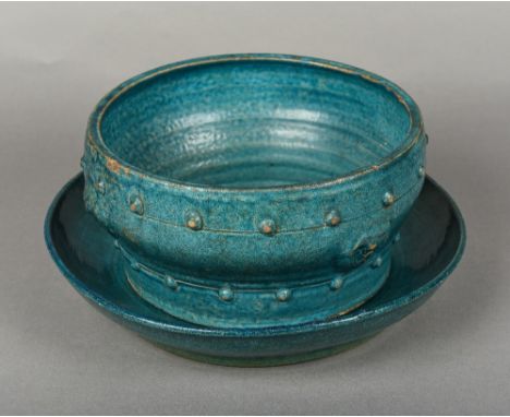 A Chinese porcelain bowl and stand, possibly Ming Both with allover turquoise glaze, the bowl with stylised mask and stud dec