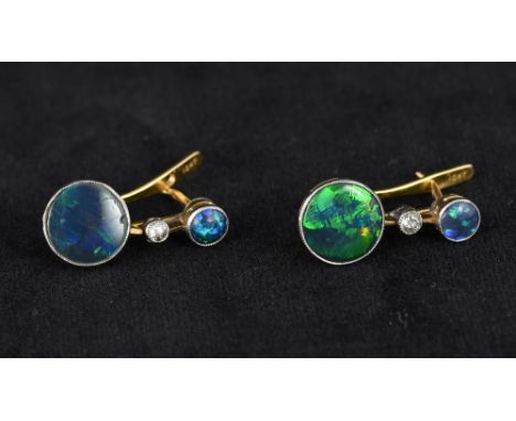 A pair of 10 kt gold opal and diamond earringsSet with two cabochon opals flanking a single diamond.  2.25 cm high.    CONDIT